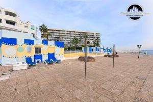 a building on the beach next to the ocean at Apartamento Castillo Santa Clara 1º Linea El Trasval in Torremolinos