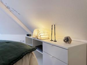 um quarto com uma cama e uma mesa com um candeeiro em Fenêtres sur mer em Cayeux-sur-Mer
