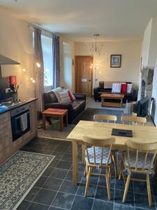 a living room with a couch and a table at Station House Self Catering, Catton in Hexham