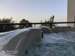 a water slide in a backyard with water at Iris Stone Villa with Jacuzzi in Tsagarada