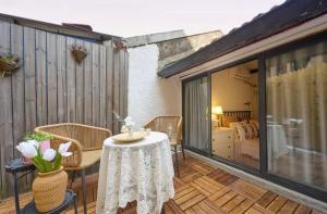 a patio with a table and chairs and a bedroom at Shanghai Hills&Well-time Scandi Loft in Shanghai