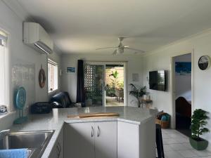 a kitchen with a sink and a counter top at Shazzas by the Sea in Vincentia