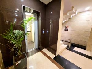 a bathroom with a potted plant and a staircase at The Nirvana By Urban Galaxy in Amritsar