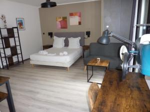 ein Wohnzimmer mit einem Sofa und einem Bett in der Unterkunft Apparts' hôtel Casa di a Restonica in Corte