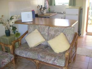 a couch with two pillows on it in a kitchen at Waterside Living CL07 in Jeffreys Bay