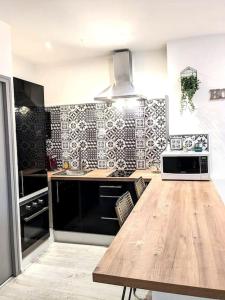 a kitchen with a wooden table in a kitchen at Le Cocon de la Cathédrale in Metz