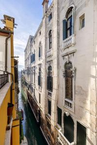 a view of a canal between two buildings at Palazzo Dei Fiori by Room Mate in Venice
