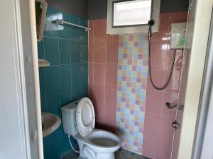 a bathroom with a toilet and a sink at โดมเขาค้อ in Ban Thung Samo