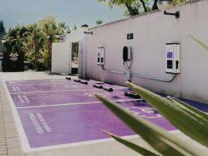 a parking lot with purple paint on the ground at Mare Hotel in Dos Hermanas