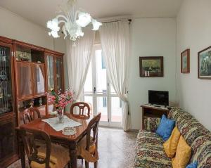 a living room with a table and a couch at AleGaia House Minori in Minori