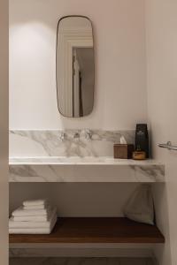 a bathroom with a sink and a mirror at De Lindenhoeve Boutique Hotel in Sluis