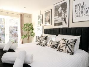 a bedroom with a large white bed with pillows at Heilan Roo in Pitlochry