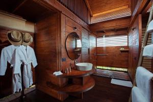 a bathroom with a sink and a mirror at Cabo Serai in Canacona