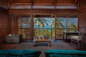 a living room with a table in a room with a view at Cabo Serai in Canacona