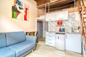 a living room with a couch and a kitchen at Petit Pierre - Hyper centre - Place Jacobins in Lyon