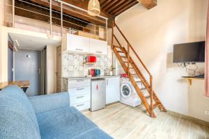 a living room with a blue couch and a kitchen at Petit Pierre - Hyper centre - Place Jacobins in Lyon +6 photos