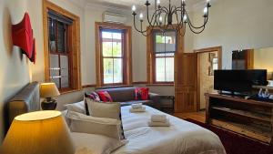 a living room with a couch and a tv at Wilton Manor SOLAR ENERGY in Cape Town