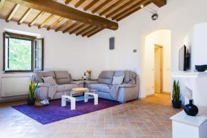 a living room with two couches and a table at Castellaccia contemporary country house in San Gimignano