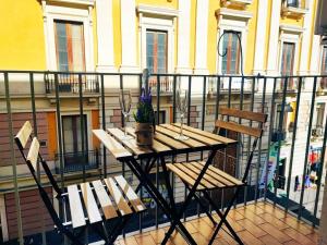 a balcony with a table and chairs on a balcony at DUHOME apartment in the heart of Catania in Catania