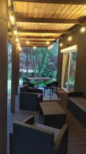 a patio with couches and tables and a table at Całkiem Klawa Enklawa in Brzozie