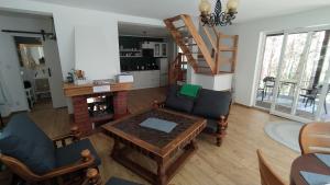 a living room with a table and chairs and a staircase at Całkiem Klawa Enklawa in Brzozie +18 photos