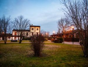 um grande edifício num parque com árvores e luzes em Afittacamere L'Agorà em Piacenza