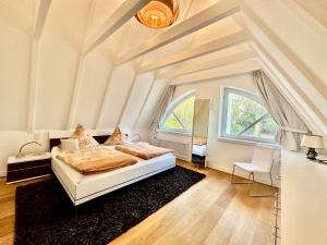 a bedroom with a bed and a large window at Villa EMG in Emsdetten