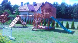 a playground in front of a house with a slide at Agroturystyka nad Wdą in Wieck