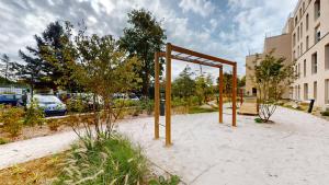 a swing set in the sand in a park at Studio 8 in Fontainebleau