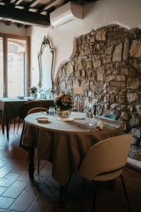 a table in a room with a stone wall at Agriturismo Fattoria Lavacchio in Pontassieve