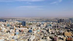 an aerial view of a city with tall buildings at Luxury Twin Room Ajman One Tower in Ajman 