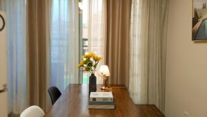 a dining room table with a vase of flowers on it at Adi Stay in Seoul