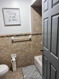 een badkamer met een toilet, een wastafel en een deur bij Elegant 3 KINGs bedroom near DWTN Newark EWR/NYC in Newark