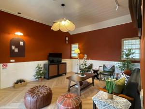 a living room with a couch and a table at 行滿旅宿&包棟烤肉親子寵物大庭院 in Zhuqi