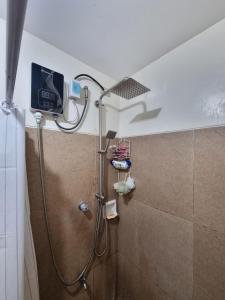 a shower in a bathroom with a shower head at Casa Simbé - Château Elyseé Staycation Parañaque in Manila