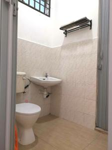 a bathroom with a toilet and a sink at White House 19 Room B in Bukit Mertajam