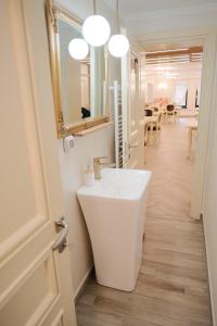 a bathroom with a white sink and a mirror at Pensiune Agroturistica Molidu in Almaş