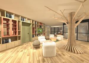 uma sala de estar com uma árvore e mobiliário branco em ibis Styles Guéret em Guéret