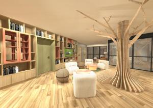 una sala de estar con un árbol y muebles blancos. en ibis Styles Guéret, en Guéret