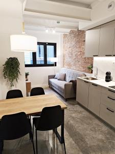 ロスピタレート・デ・リョブレガートにあるARIQUS Fira Apartmentsのキッチン、リビングルーム(テーブル、椅子付)