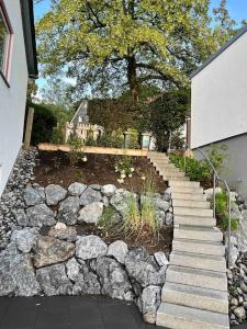 Luxurious Villa near Cologne, Düsseldorf and Essen في فوبرتال: طريق حجري يؤدي الى حديقة فيها شجرة