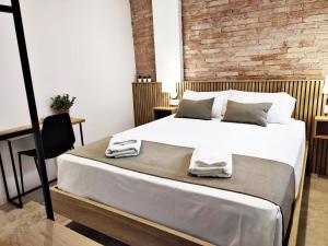 ARIQUS Fira Apartments客房内的一张或多张床位