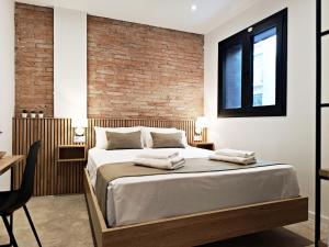 ARIQUS Fira Apartments客房内的一张或多张床位