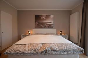a bedroom with a large bed with two night stands at Luxurious Villa near Cologne, Düsseldorf and Essen in Wuppertal