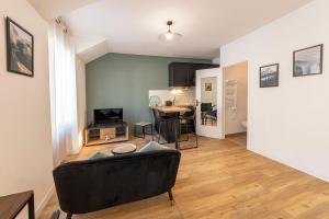 a living room with a couch and a table at Coquelin - Joli appartement rénové in Rennes