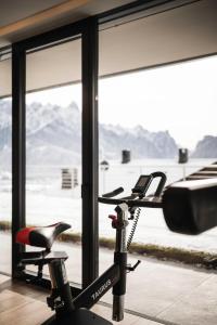 a bike parked in a room with a window at Timeless Dolomites Apartments in Dobbiaco