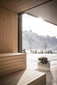 a room with a window with a view of the mountains at Timeless Dolomites Apartments in Dobbiaco