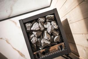 a pile of rocks in a box on a wall at Timeless Dolomites Apartments in Dobbiaco