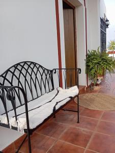 a bench sitting in a room with a porch at Villa Romero in Mairena del Alcor