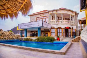 a house with a swimming pool in front of it at The Keza Hotel and Apartments in Kigali